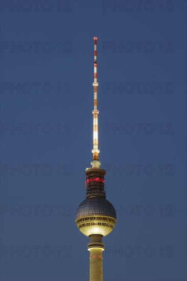 Television tower illuminated at blue hour