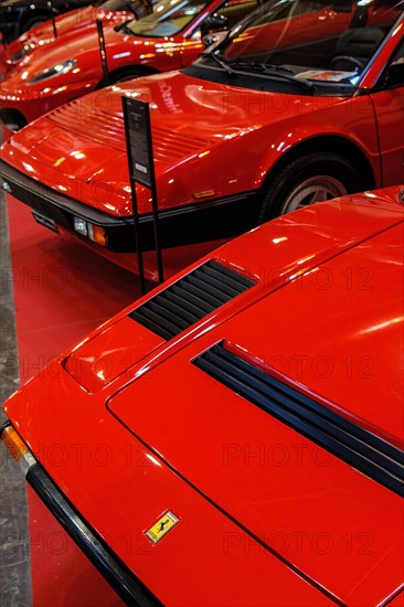 Front front bonnet of classic car red Ferrari 308 behind Ferrari Mondial