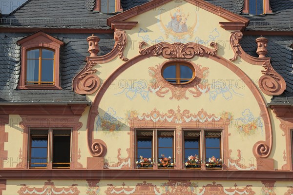 Detail of historic house with ornaments and mural on the market