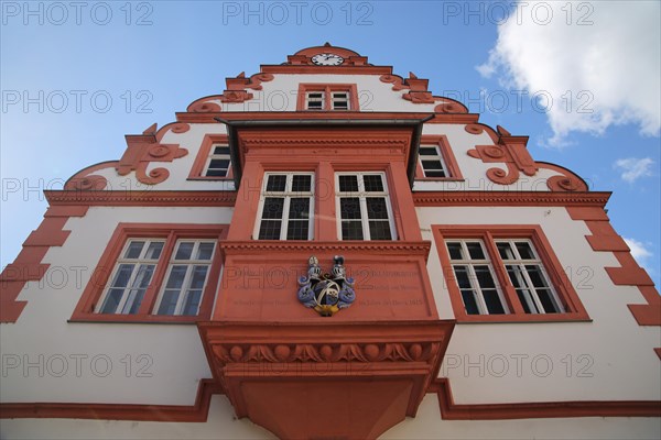 Renaissance town hall with oriel and coat of arms and tail gable