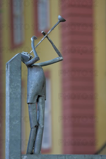 Modern sculpture as trumpeter made of metal