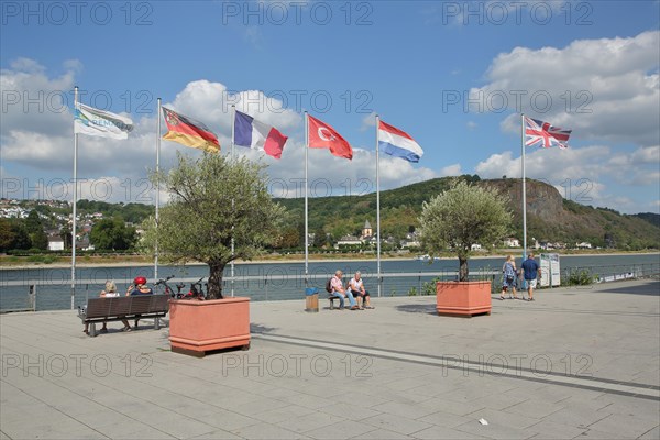 View from the banks of the Rhine with national flags and people in Unkel on Erpeler Ley