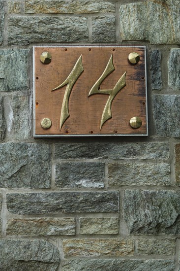 House number 14 made of brass with copper and rivets