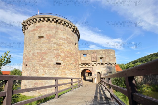 Historic medieval moated castle with bulwark and bridge