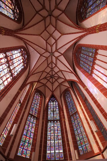 Interior view with stained glass window and ceiling vault of St. Catherine's Church