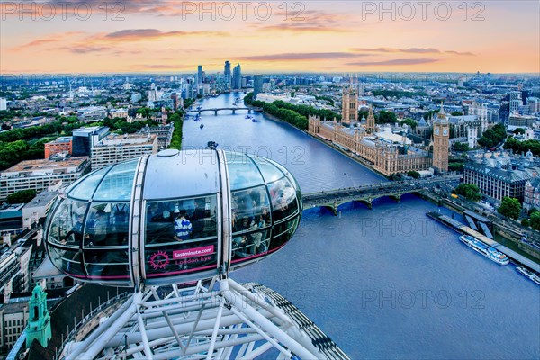 Gondola of the London Eye Ferris Wheel over the Thames with the Houses of Parliament in the evening mood