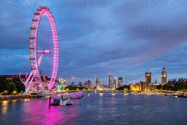 London Eye Ferris Wheel on the banks of the Thames at dusk