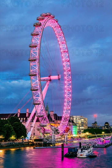 London Eye Ferris Wheel on the banks of the Thames at dusk