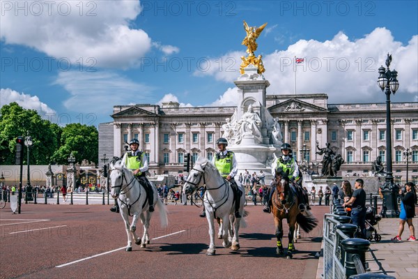 Mounted police in front of the Victoria Memorial at Buckingham Palace