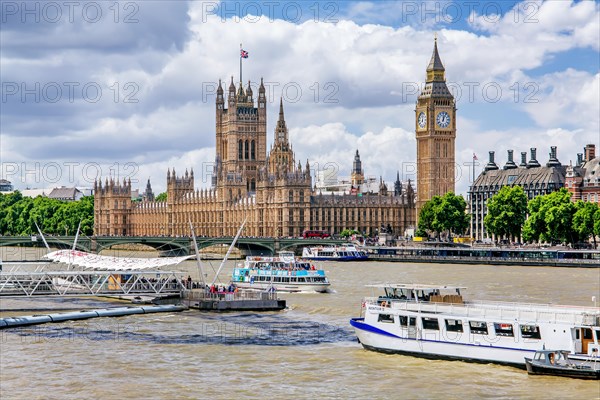 Excursion boats on the Thames with the Houses of Parliament and the clock tower Big Ben