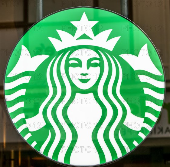 Close up of Starbucks twin-tailed siren brand logo sign