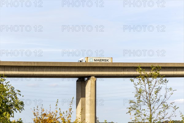HGV truck lorry Maersk container vehicle driving on rasied section of Orwell Bridge