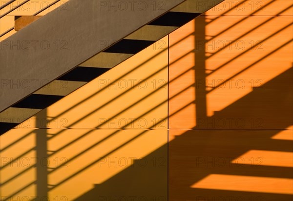 Shadow of a staircase falls on wall