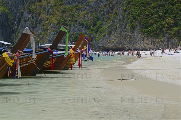 Tourists and traditional longtail boats