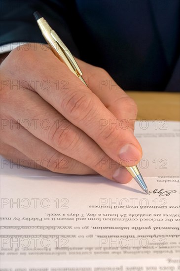 Businessman signing a document