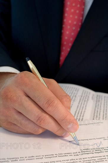 Businessman signing a legal document