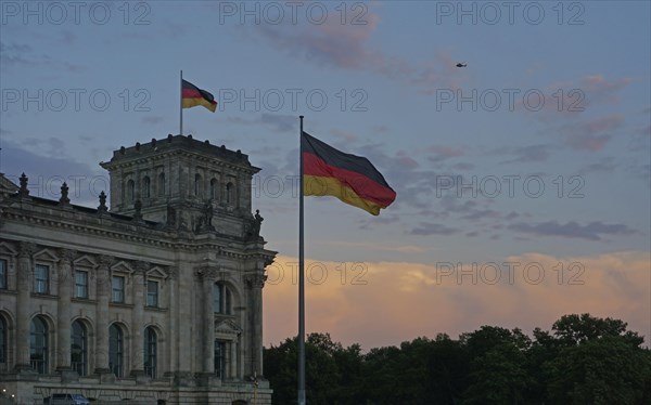 German flags flying at sunset at the Reichstag