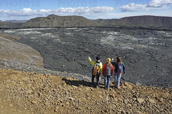 Hikers look down on solidified lava