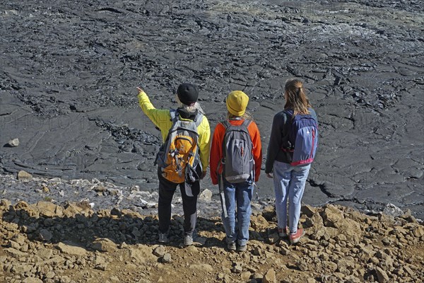 Hikers look down on solidified lava