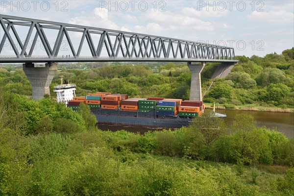 Container ship under the bridge of Gruenental