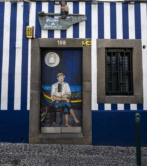 Colourfully painted door with fisherman