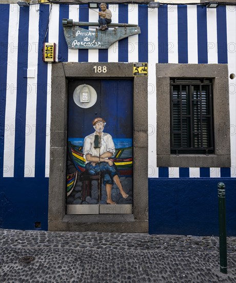 Colourfully painted door with fisherman