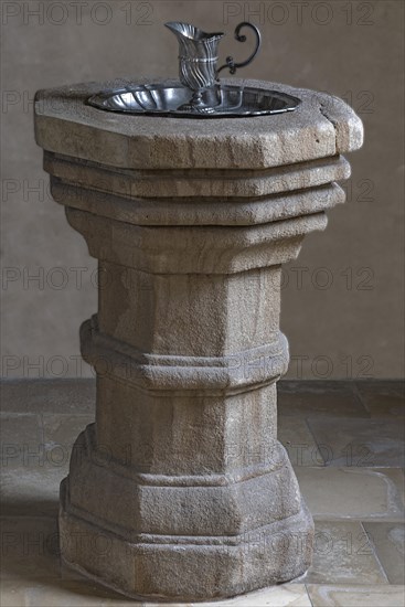 Historic 16th century baptismal font with baptismal font