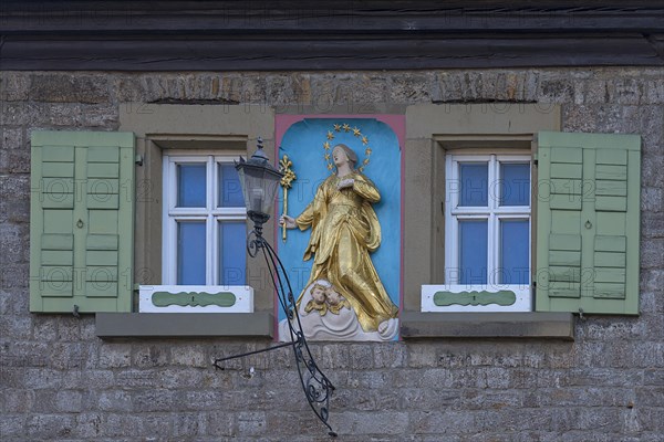 Figure of a saint on a house facade