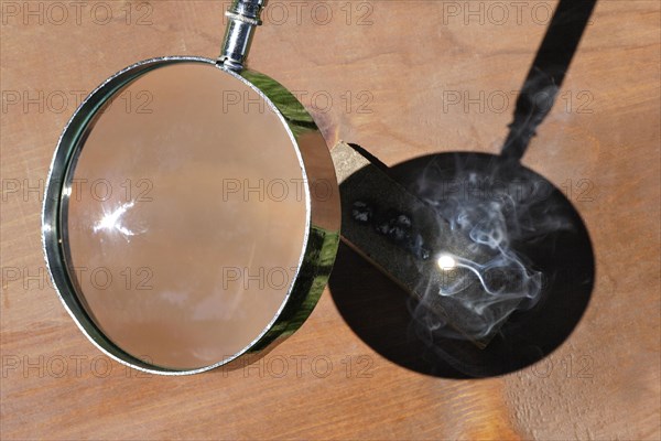 Magnifying Glass Concentrating Sunlight and Generating High Temperatures