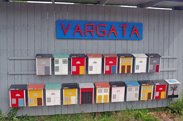 Colourful painted mailboxes on wood
