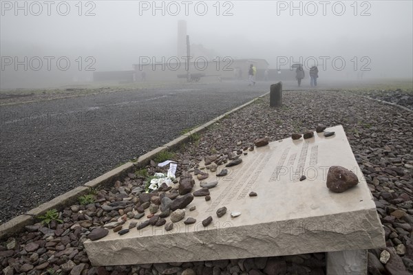 Memorial plaque with crematorium in the fog at beech forest Concentration Camp