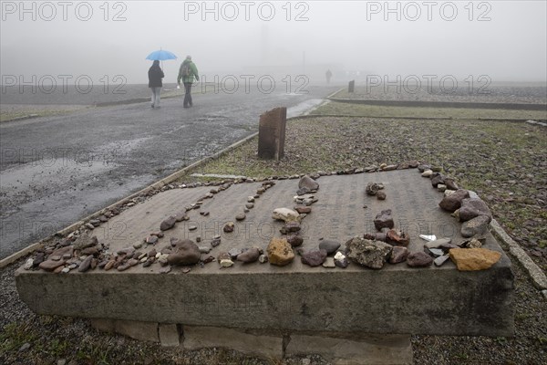 Memorial plaque with crematorium in the fog at beech forest Concentration Camp