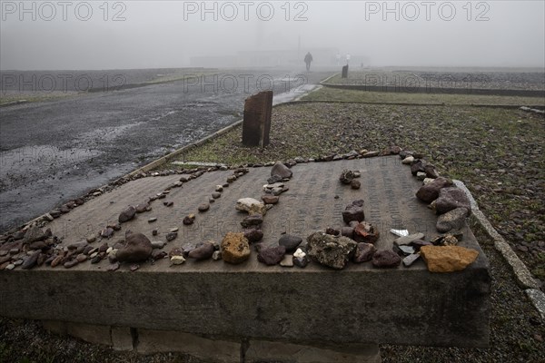 Memorial plaque with crematorium in the fog at beech forest Concentration Camp