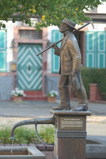 Winegrower's fountain with standing collar winegrower sculpture at the market place in Martinsthal