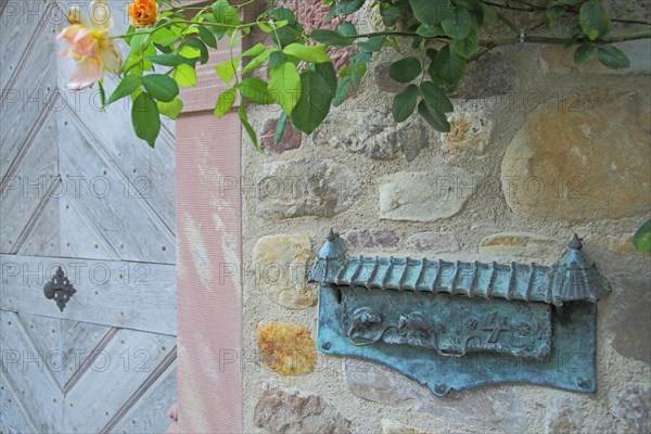 Door with decorated letterbox and roses in Burgstrasse