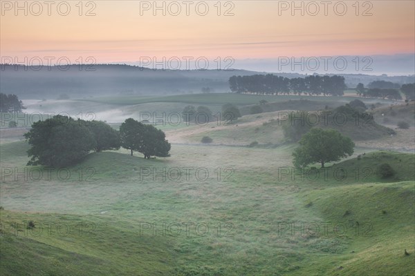 Early morning mist at sunrise in the hills of Broesar backar