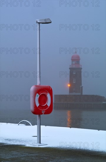 Lighthouse at the mouth of the river Geese in Bremerhaven in the fog