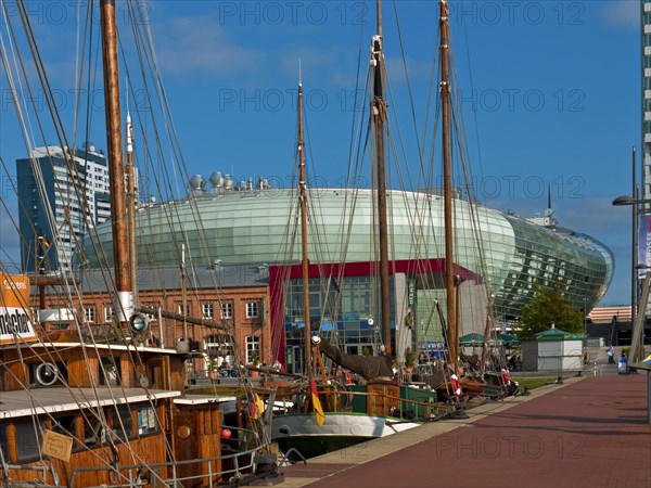 Old sailing ships in the harbour with the Klimahaus in the background