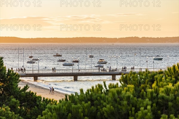 Boats and jetty in Arcachon Bay in the evening light