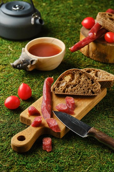 Snack in the woods with dried thin sausage