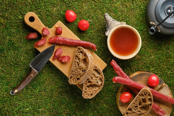 Top view of snack in the woods with dried thin sausage