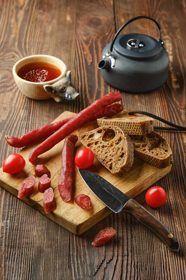 Dry thin pork sausage on cutting board