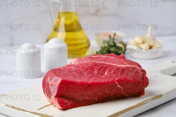 Closeup view of raw top side beef steak with spice ready for cooking