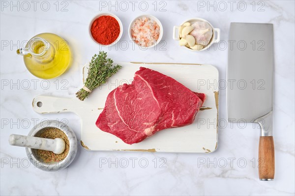 Top view of raw top side beef steak with spice ready for cooking