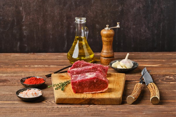 Raw beef brisket flat steak on wooden tabletop ready for cooking