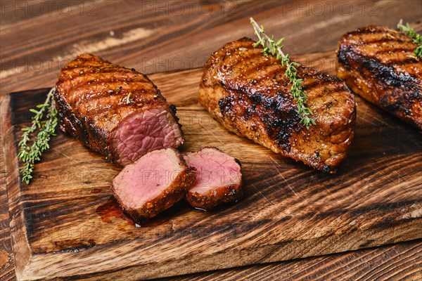 Closeup view of roasted beef brisket flat steak on wooden cutting board