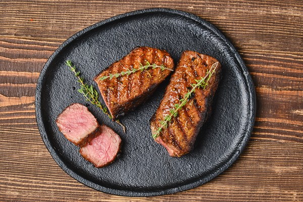 Closeup view of grilled beef brisket flat steak on a plate