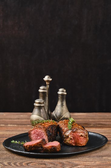 Low angle view of roasted beef steak and slices