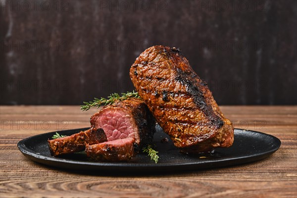 Closeup view of roasted beef brisket flat steak on a plate