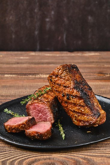 Closeup view of grilled beef brisket flat steak on wooden table